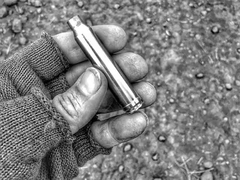Matt, holding a used rifle shell in his hand