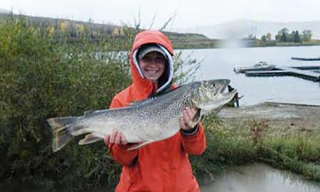 Angler holding a large, caught tiger trout