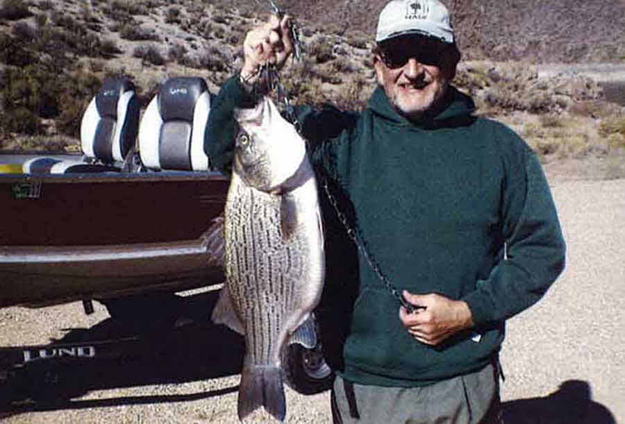Angler holding a caught, record-sized wiper fish at Newcastle Reservoir