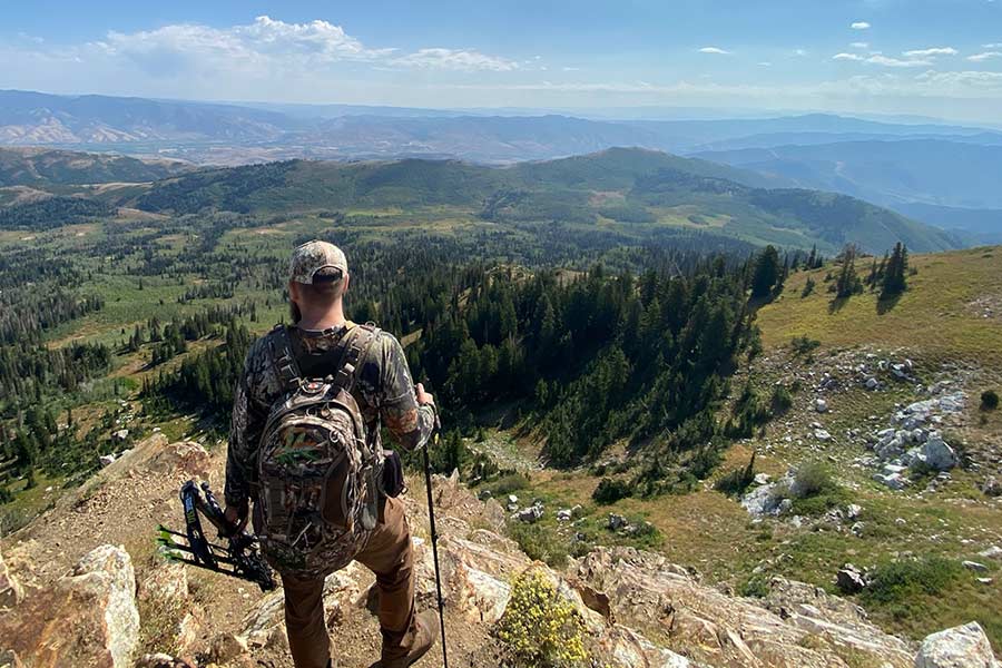 Archery hunter overlooking a valley